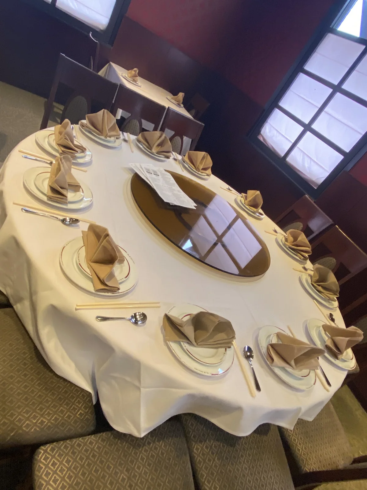 A round banquet table with a lazy Susan set for a party