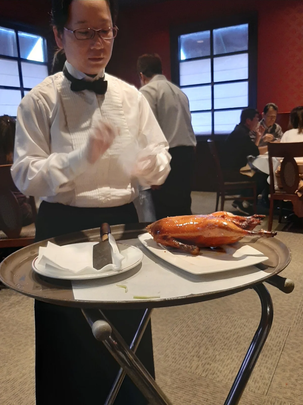 A Hong Hua server bringing Peking duck to the table on a cart